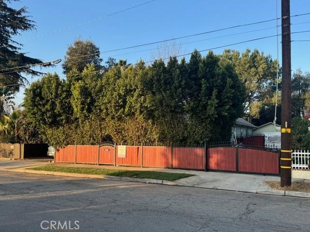 1355 N Gordon St, Pomona, CA 91768 - view of asphalt road featuring curbs, sidewalks, and a gate