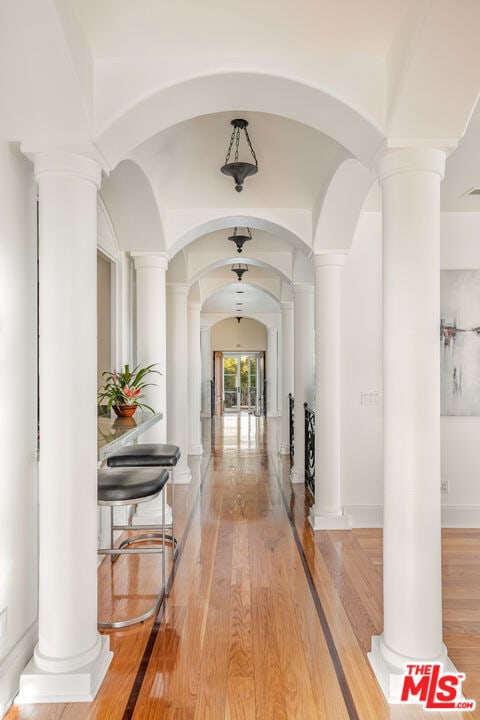 corridor with hardwood / wood-style floors