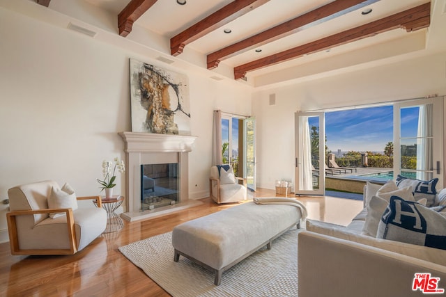 living room featuring hardwood / wood-style floors and beamed ceiling