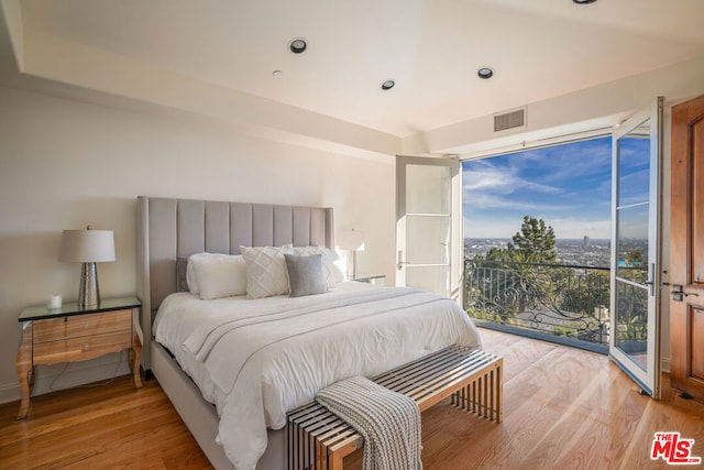 bedroom with light wood-type flooring and access to outside