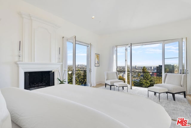 bedroom featuring a fireplace and access to outside