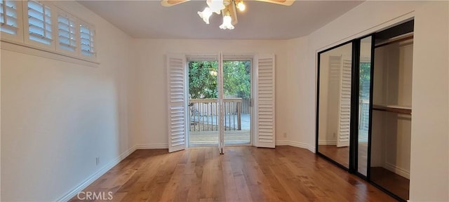 doorway with light wood-type flooring and ceiling fan