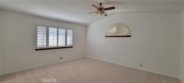 carpeted empty room with vaulted ceiling and ceiling fan