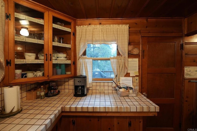 kitchen featuring backsplash, tile counters, and wooden ceiling