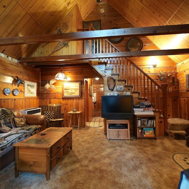 living room featuring beam ceiling, wood walls, carpet floors, and wooden ceiling