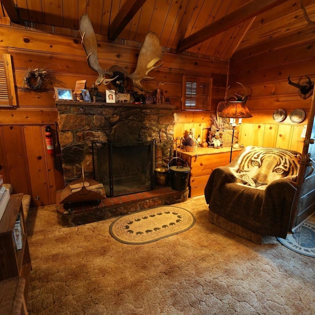 living room with a fireplace, carpet, beamed ceiling, and wooden ceiling