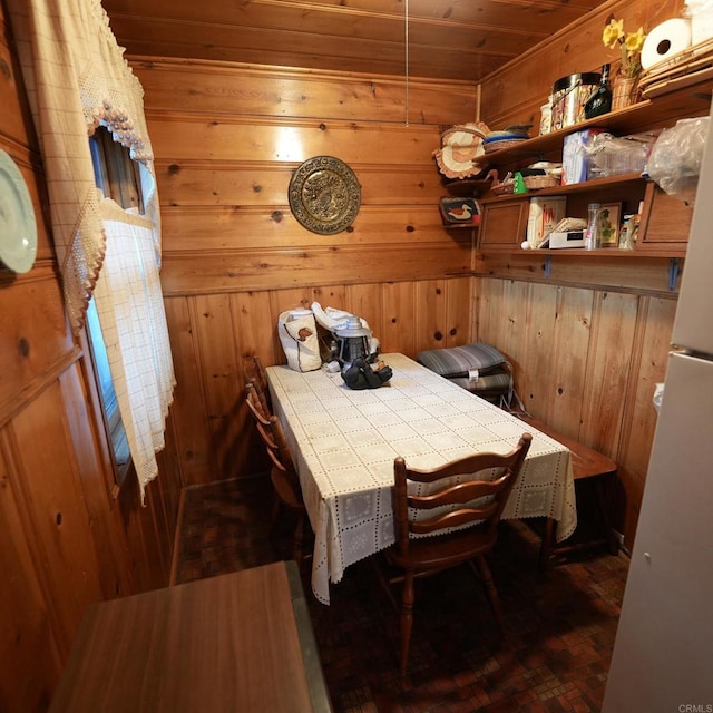 dining area with breakfast area, wooden ceiling, dark wood-type flooring, and wooden walls