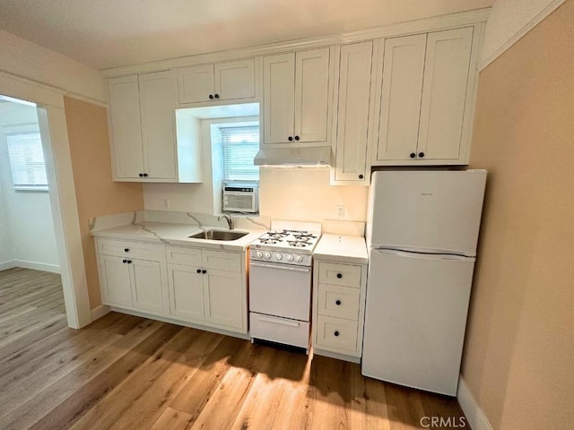 kitchen featuring light wood-type flooring, white appliances, and white cabinets