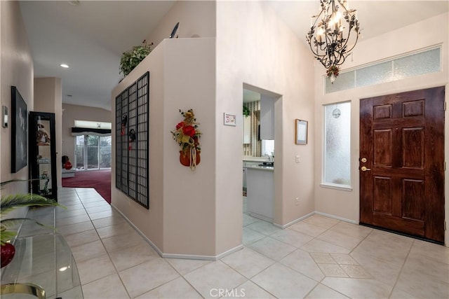 entrance foyer with light tile patterned floors and a chandelier