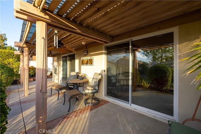 view of patio / terrace with ceiling fan and a pergola