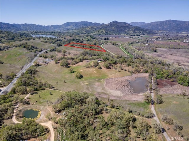 birds eye view of property featuring a mountain view and a rural view