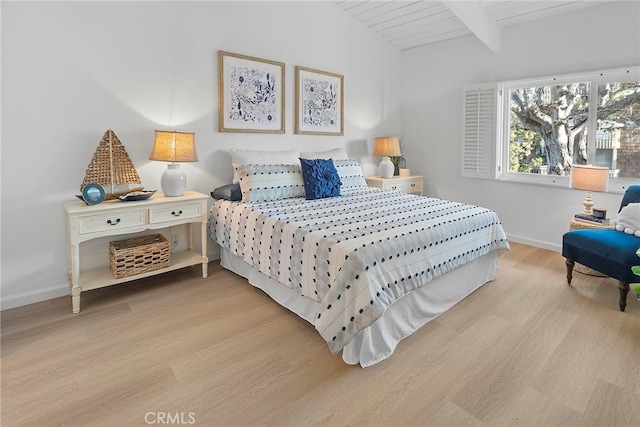 bedroom with lofted ceiling with beams, light wood-type flooring, and wood ceiling