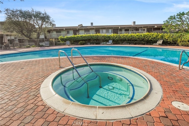 view of pool with a community hot tub