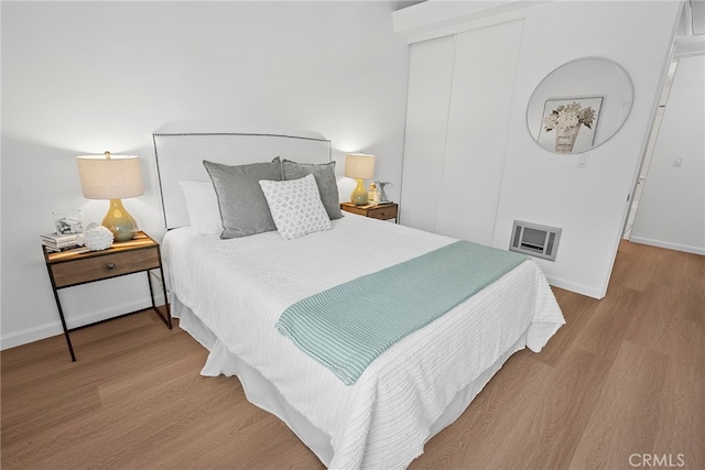 bedroom featuring a closet and light hardwood / wood-style flooring