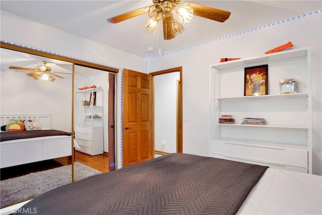 bedroom with hardwood / wood-style floors, a closet, and ceiling fan