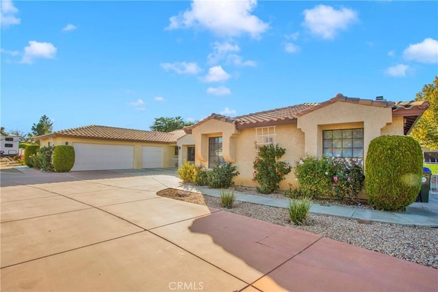 mediterranean / spanish home featuring a garage