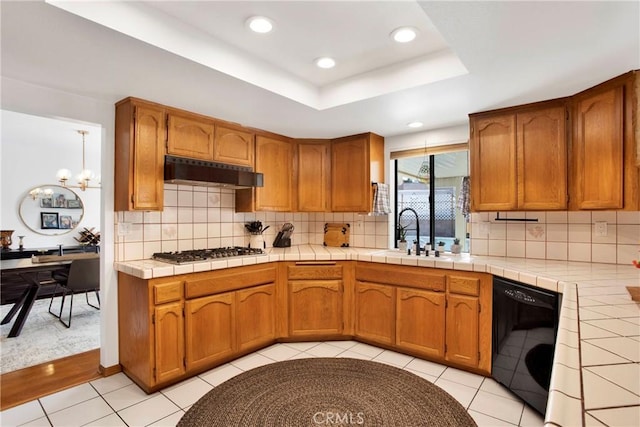 kitchen featuring stainless steel gas cooktop, sink, tile countertops, dishwasher, and light tile patterned flooring