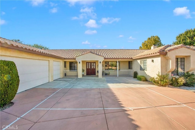 mediterranean / spanish home with a garage