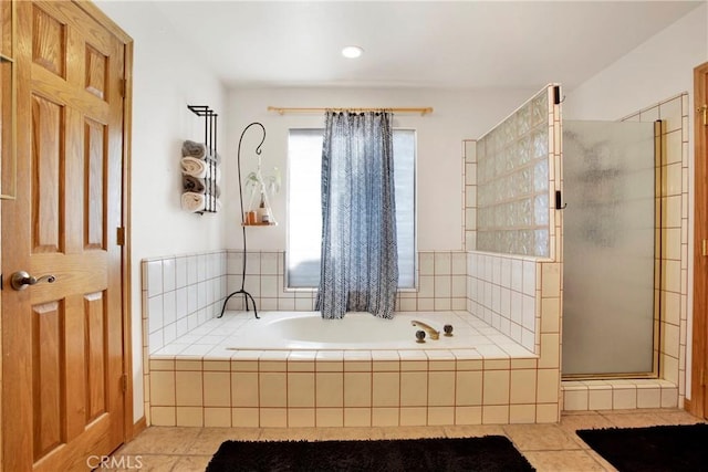 bathroom with tile patterned flooring and independent shower and bath