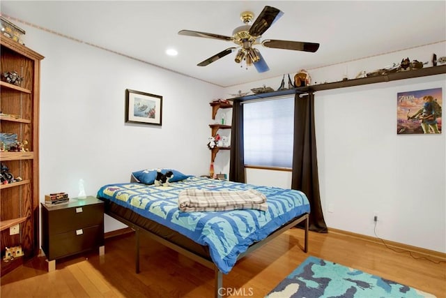 bedroom with ceiling fan and light hardwood / wood-style floors