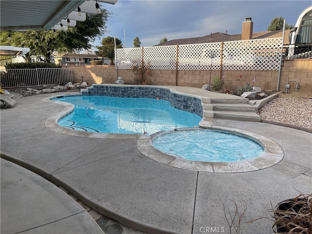 view of pool featuring an in ground hot tub