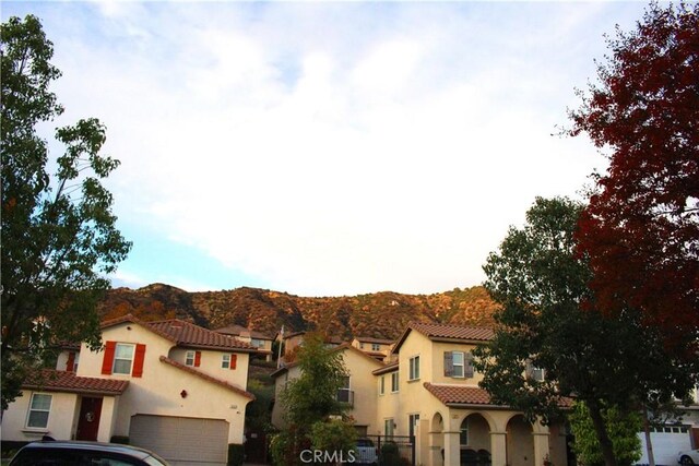 view of front of property featuring a mountain view and a garage