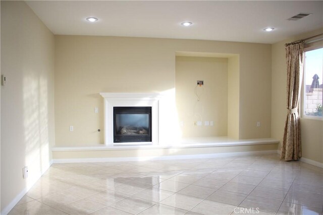 unfurnished living room with light tile patterned floors