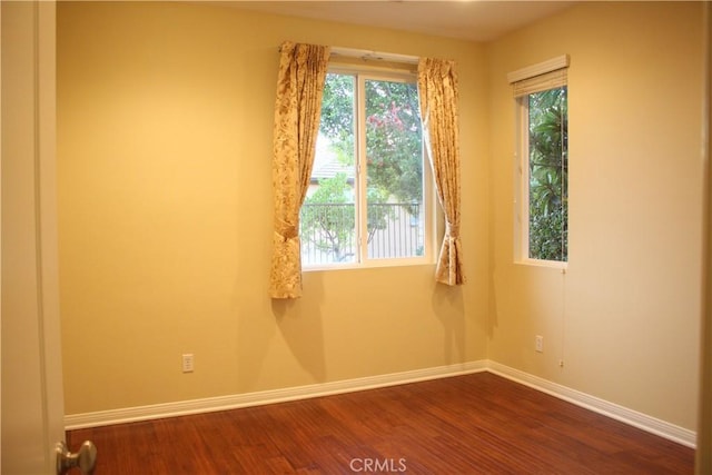 empty room with dark wood-type flooring