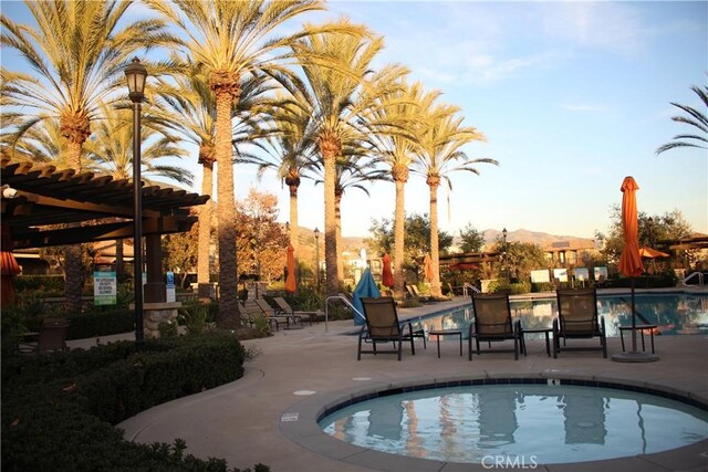 view of pool with a mountain view and a patio