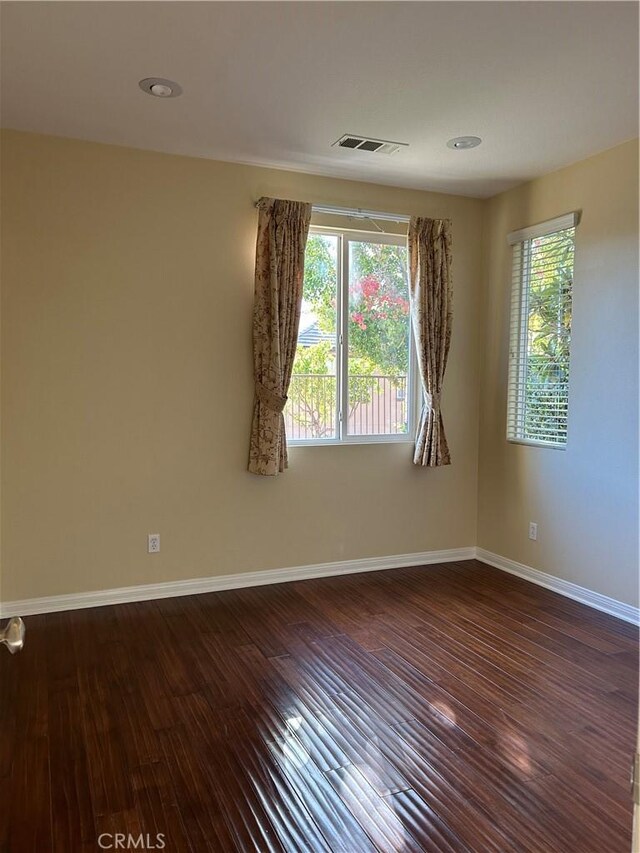 empty room with hardwood / wood-style flooring