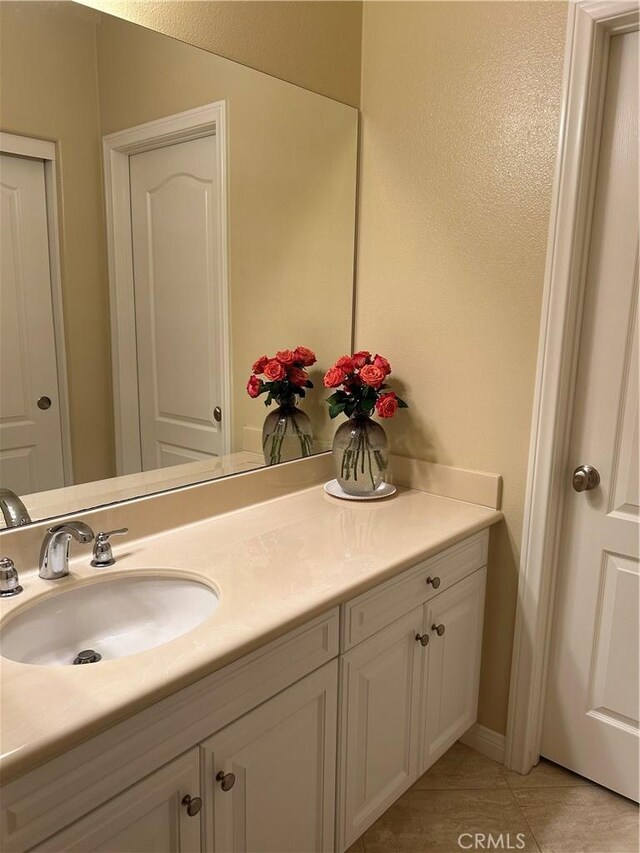 bathroom with tile patterned floors and vanity