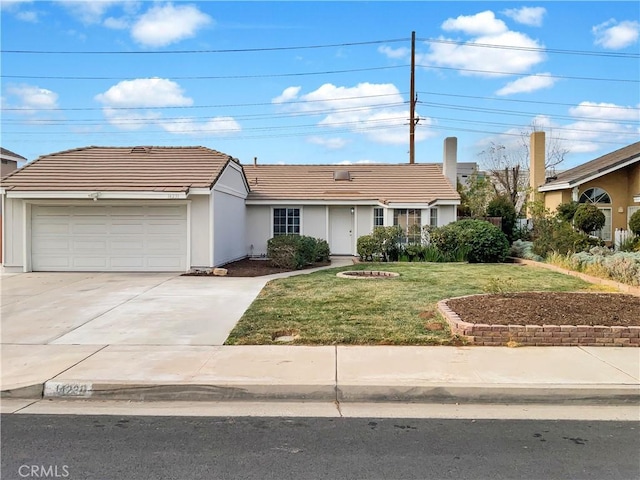 ranch-style home featuring a garage and a front lawn