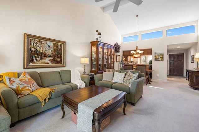 carpeted living room with beamed ceiling, high vaulted ceiling, and ceiling fan with notable chandelier