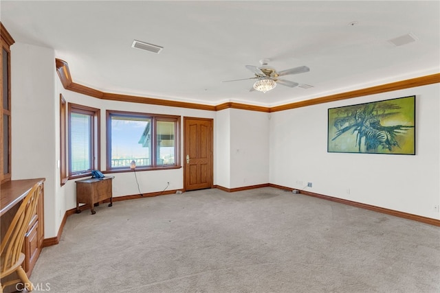 carpeted empty room featuring ceiling fan and ornamental molding