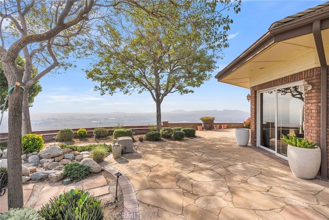 view of patio / terrace featuring a mountain view