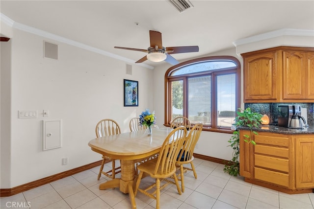 dining room featuring light tile patterned floors, ceiling fan, and crown molding