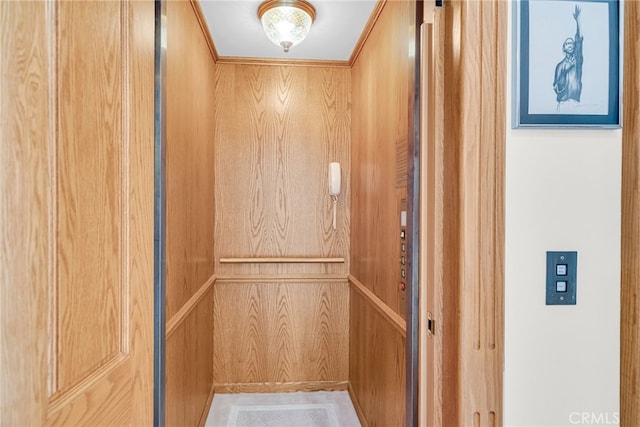 details featuring wooden walls and elevator