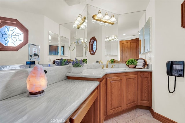 bathroom with tile patterned flooring, vanity, and a chandelier