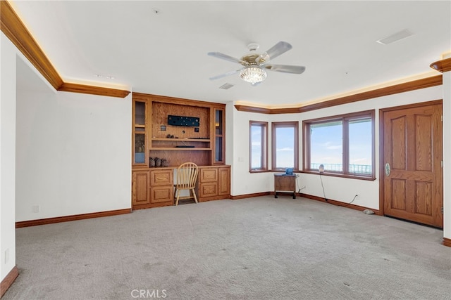 unfurnished living room with light carpet, ceiling fan, and crown molding