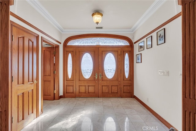 foyer entrance featuring crown molding