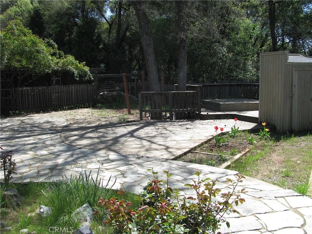 view of patio featuring a shed