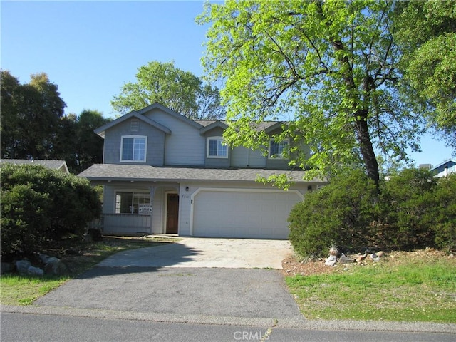 view of front of home with covered porch and a garage