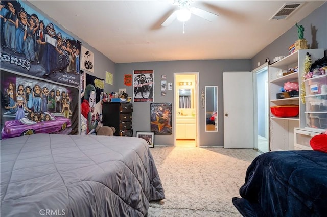 carpeted bedroom with ceiling fan and ensuite bathroom