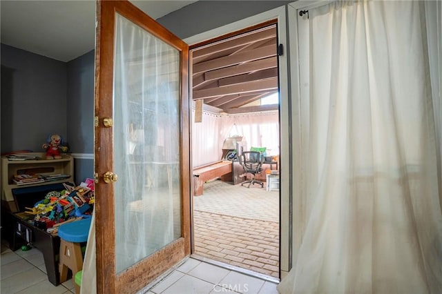 doorway to outside featuring light tile patterned floors