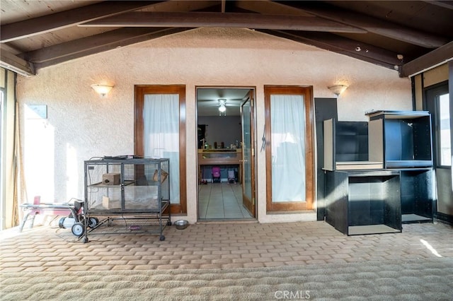 living room with vaulted ceiling with beams and carpet