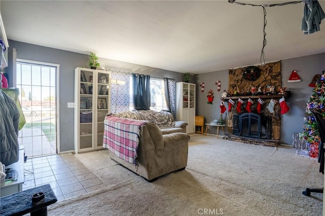 living room featuring tile patterned floors and a stone fireplace