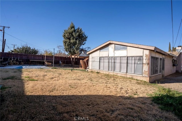 rear view of property with a fenced backyard