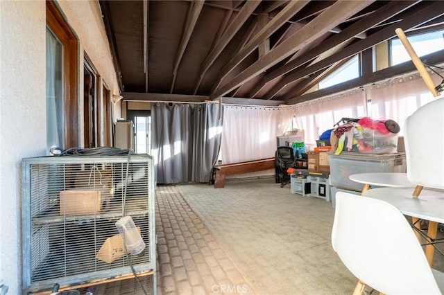 misc room featuring carpet flooring and vaulted ceiling