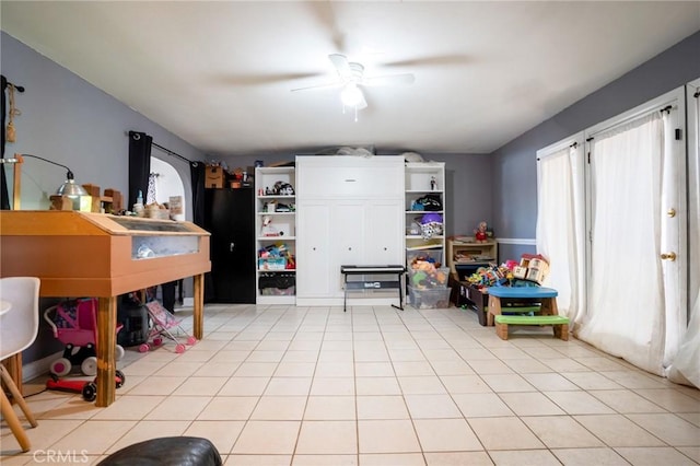 rec room with light tile patterned floors and ceiling fan