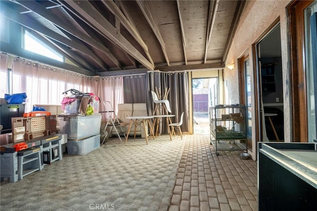 interior space featuring carpet floors and vaulted ceiling